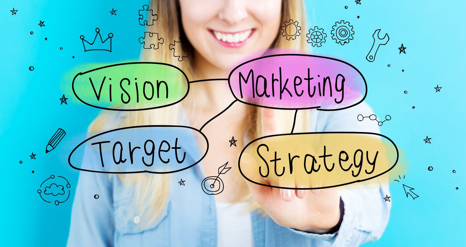 woman smiling in front of blue background at colourful key words, vision, marketing, target and strategy