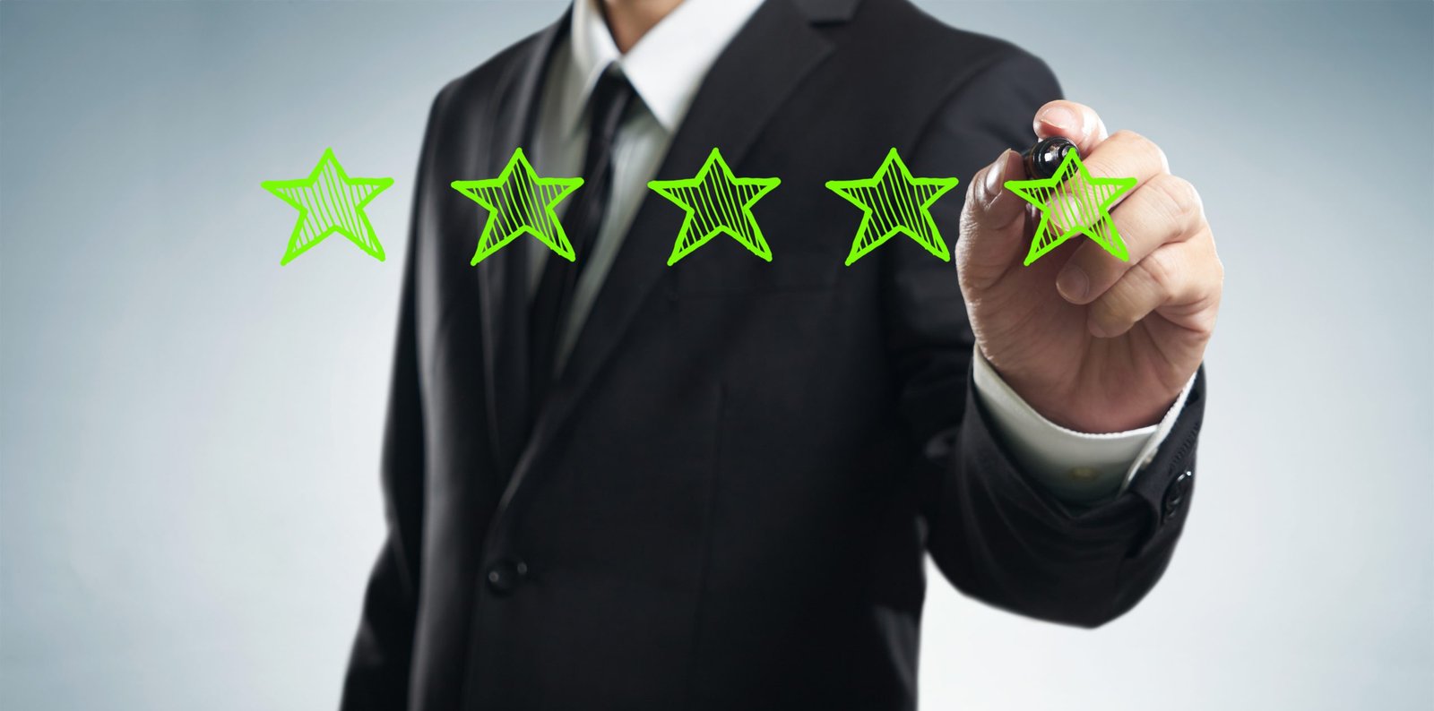 man drawing 5 stars onto screen for Business Rating Review